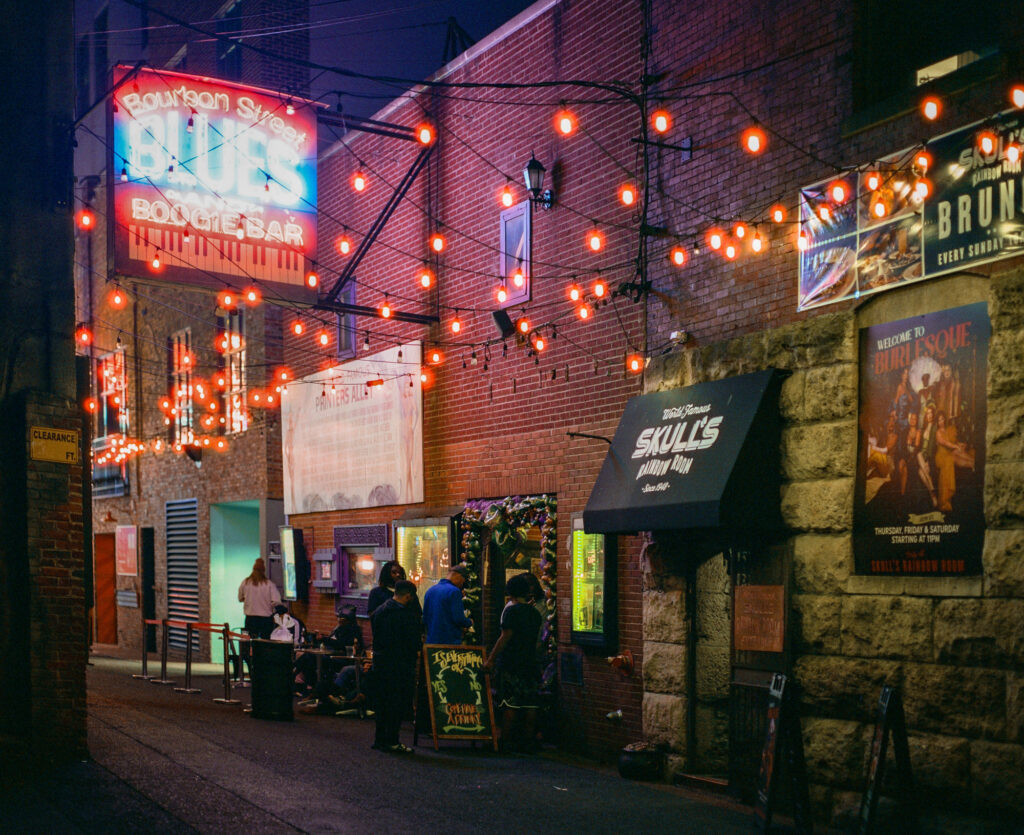 Bourbon Street Blues and Boogie Bar illuminated at night in Nashville's Printers Alley, photographed on a Pentax 67 using CineStill 800T medium format film.